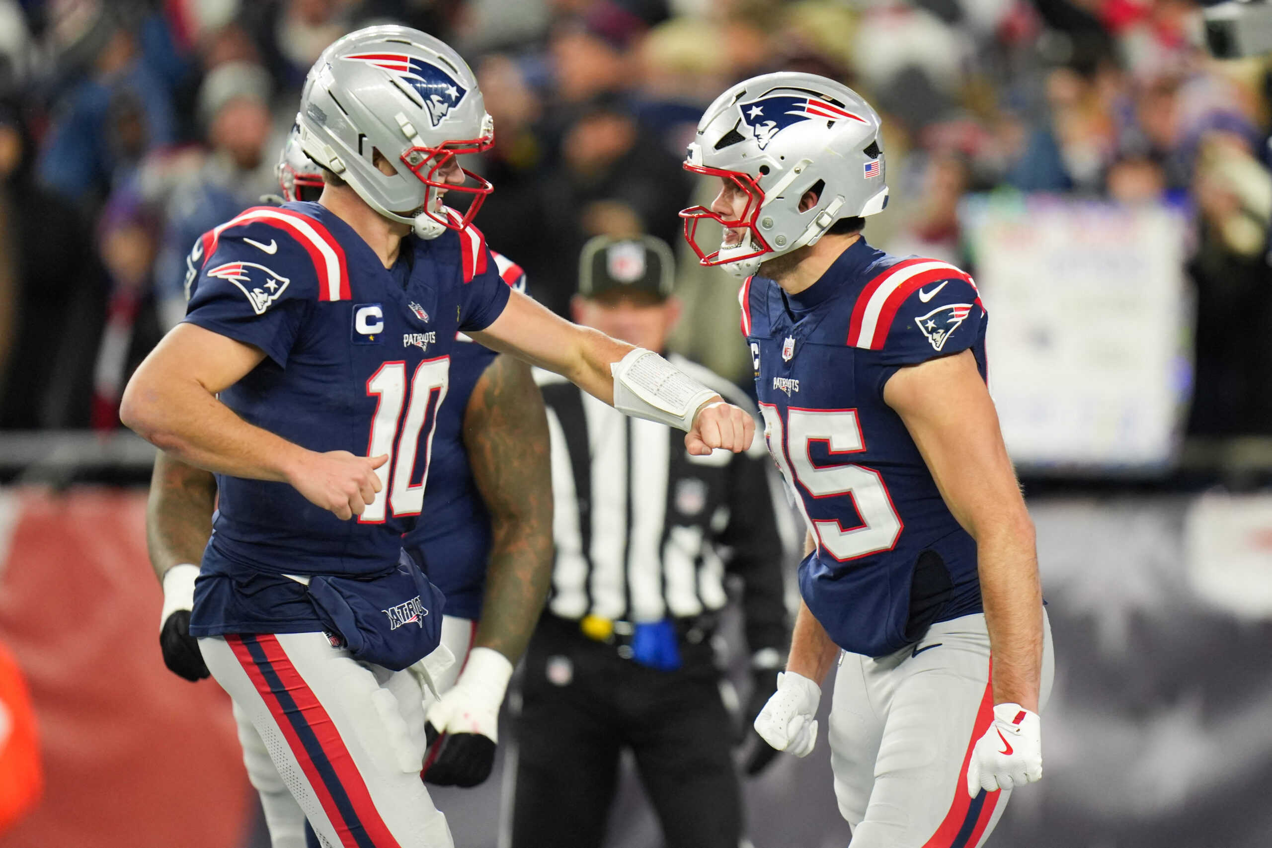 Jan 11, 2026; Foxborough, MA, USA; New England Patriots tight end Hunter Henry (85) celebrates with New England Patriots quarterback Drake Maye (10) after scoring a touchdown during the fourth quarter against the Los Angeles Chargers in an AFC Wild Card Round game at Gillette Stadium. Mandatory Credit: David Butler II-Imagn Images
