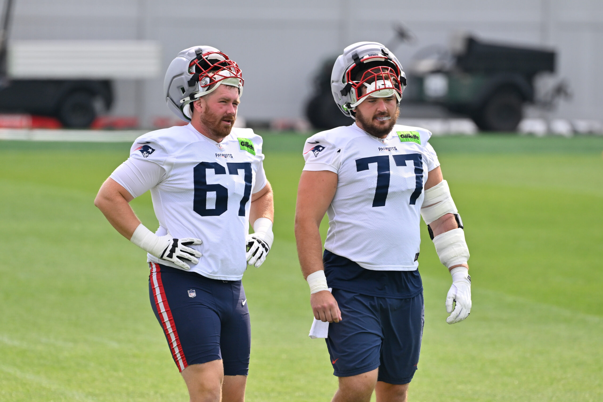 Jul 28, 2026; Foxborough, MA, USA; New England Patriots offensive tackle Andrew Rupcich (67) and center Ben Brown (77) walk to practice for training camp at Gillette Stadium. Mandatory Credit: Eric Canha-Imagn Images