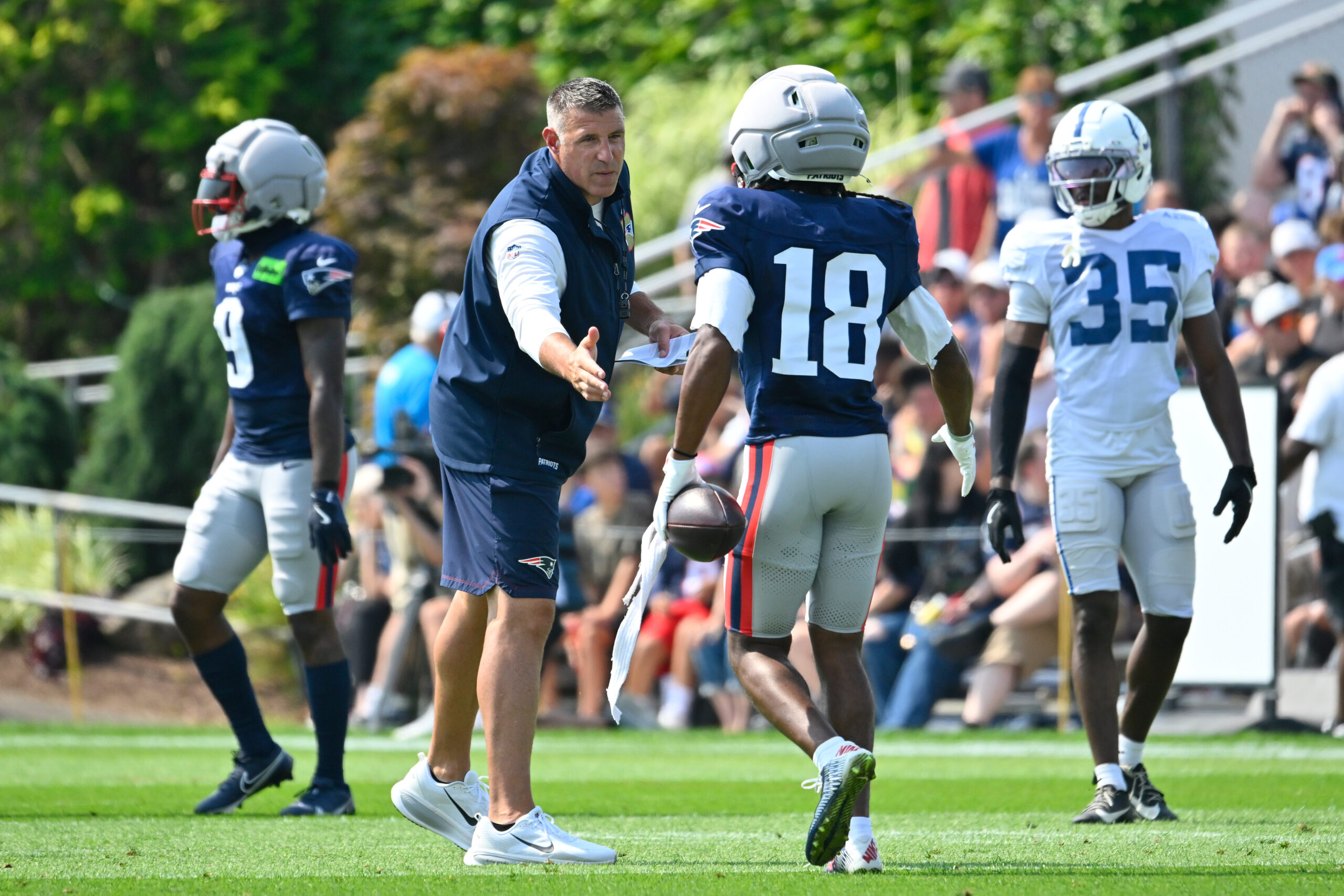 Aug 11, 2026; Foxborough, MA, USA; New England Patriots head coach Mike Vrabel shakes hands with wide receiver Kyle Williams (18) during a joint practice with the Indianapolis Colts at Gillette Stadium. Mandatory Credit: Eric Canha-Imagn Images