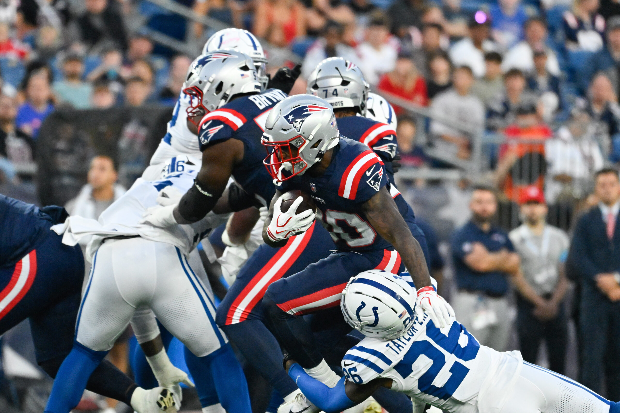 Aug 13, 2026; Foxborough, Massachusetts, USA; New England Patriots running back Jam Miller (30) runs the ball against Indianapolis Colts cornerback Cam Taylor-Britt (26) during the first half at Gillette Stadium. Mandatory Credit: Eric Canha-Imagn Images