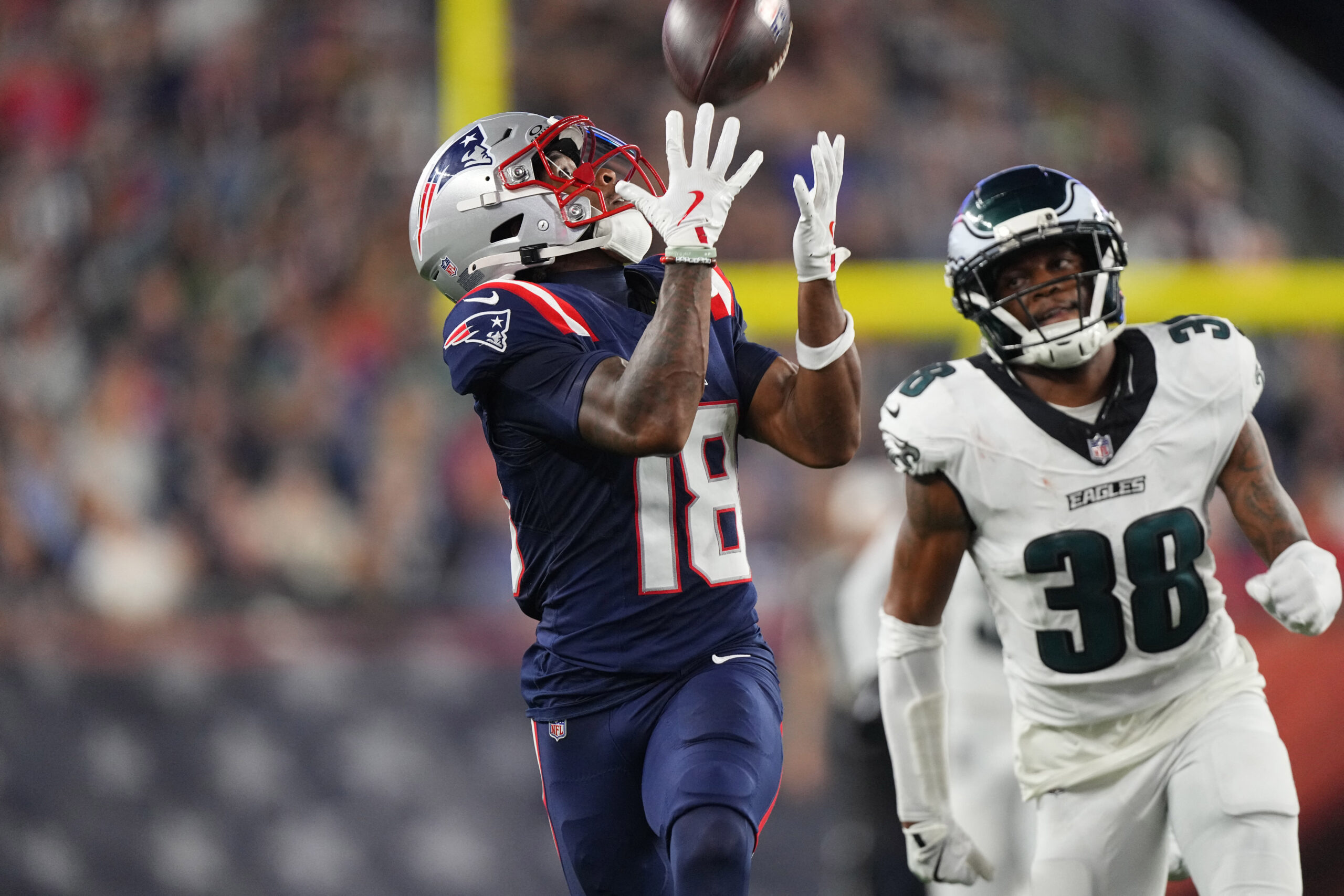 Aug 22, 2026; Foxborough, Massachusetts, USA; New England Patriots wide receiver Kyle Williams (18) catches a pass against Philadelphia Eagles cornerback Ambry Thomas (38) and runs for a touchdown during the first half at Gillette Stadium. Mandatory Credit: Gregory Fisher-Imagn Images