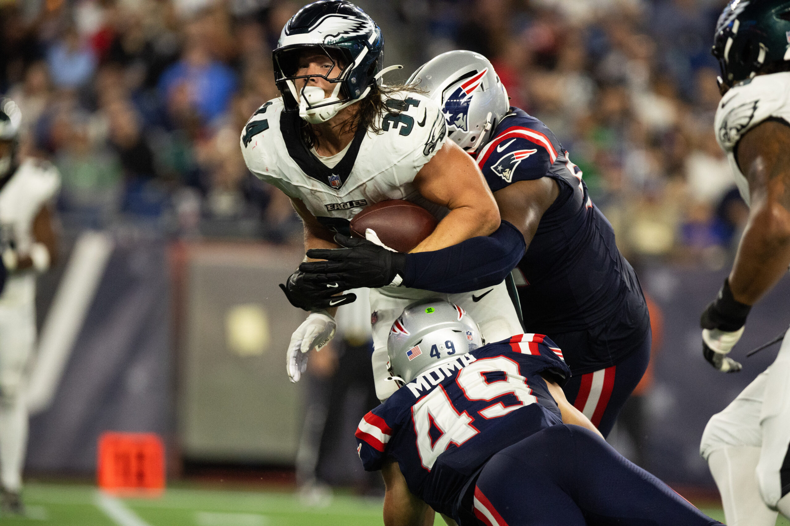 Aug 22, 2026; Foxborough, Massachusetts, USA; New England Patriots linebacker Chad Muma (49) tackles Philadelphia Eagles running back Carson Steele (34) in the second half at Gillette Stadium. Mandatory Credit: Edward Finan-Imagn Images