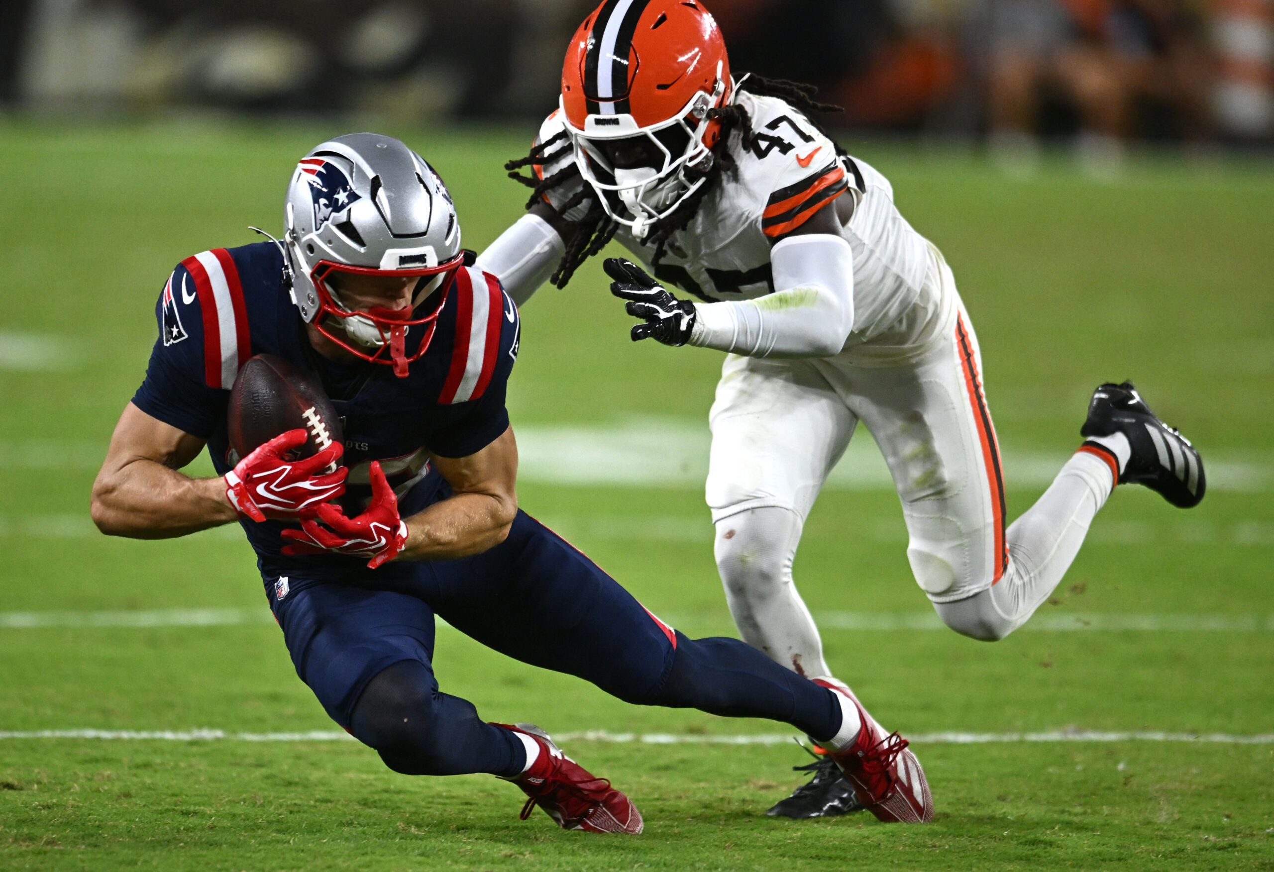 Aug 27, 2026; Cleveland, Ohio, USA; New England Patriots wide receiver Kyle Dixon (83) catches a pass in front of Cleveland Browns defensive back Jeremiah McClendon (47) during the second half at Huntington Bank Field. Mandatory Credit: Ken Blaze-Imagn Images